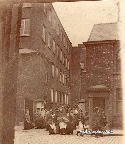 Workers leaving the Hollins Mill via the entrance on Stockport Road around 1890. 