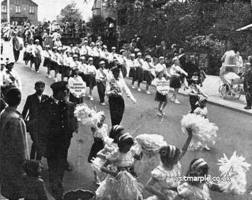 A troup of dancers make their way down Brabyns Brow