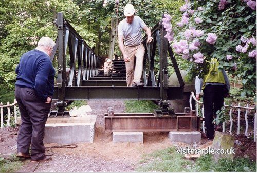 The Bailey Bridge is installed in July 1992. Reg Walters (left), owner of Iron Bridge Cottage, keeps a close watch on the workers.