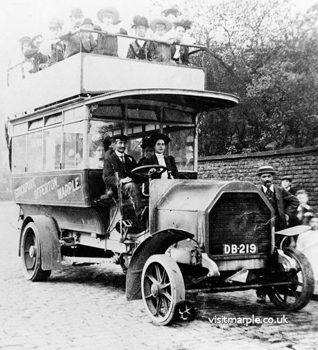 The first motor bus in Marple on 21 October 1908. Edith Elizabeth Bridge (nee Clayton) sitting and Mr Clayton - bus owner - standing. From Marple Local History Society Archives. 