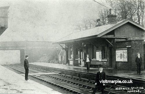 Railway workers and passengers posing at Rose Hill Station. 