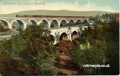 An Up Great Central train of 14 six-wheeled carriages headed by a diminutive tank engine crosses Marple Viaduct.